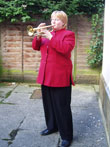 Heather Wannell playing the Last Post outside the Alison Fielden & Co. offices